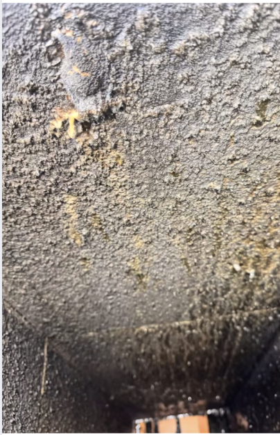 Before — Horizontal duct run — heavy carbon buildup removed through access panels.