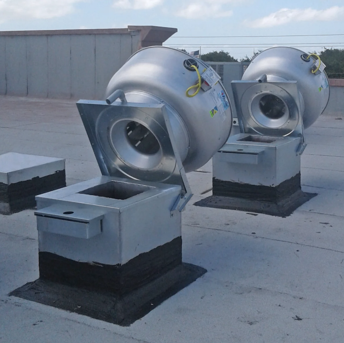 After — Rooftop exhaust fans — grease-laden housings degreased to bare metal. Bay Area restaurant.