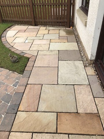 After — Pressure Washing — patio and walkway stone stripped of algae and stains.