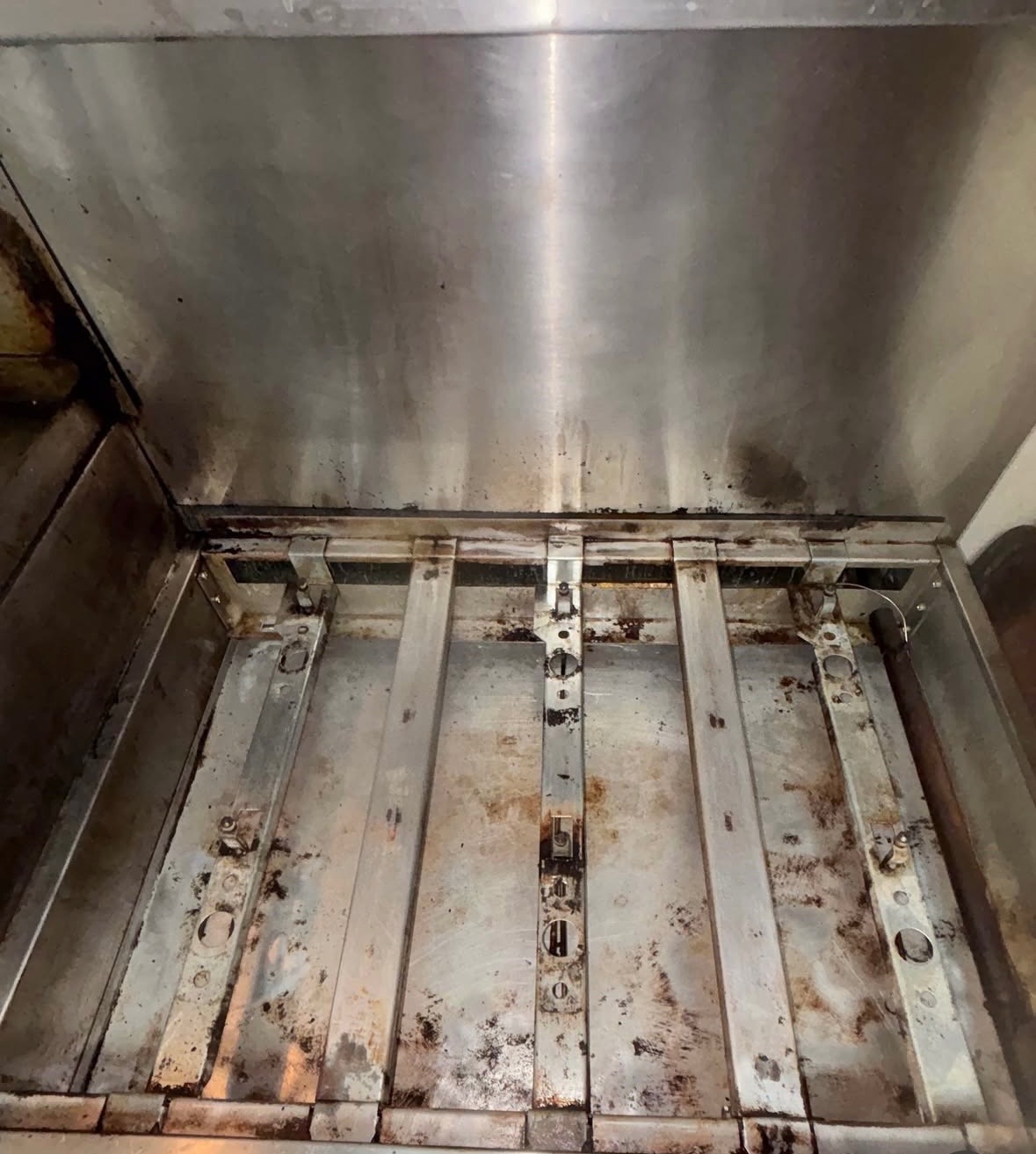 After — Commercial charbroiler — burners, grates, and grease-caked interior scraped and degreased.