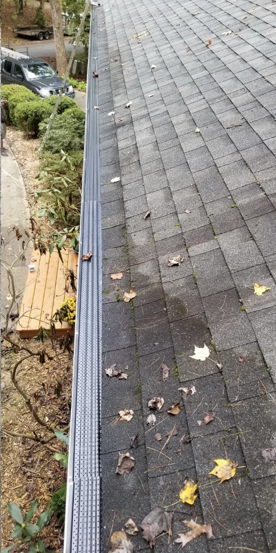 After — Gutter Guards — debris-packed gutters cleared and fitted with guards.